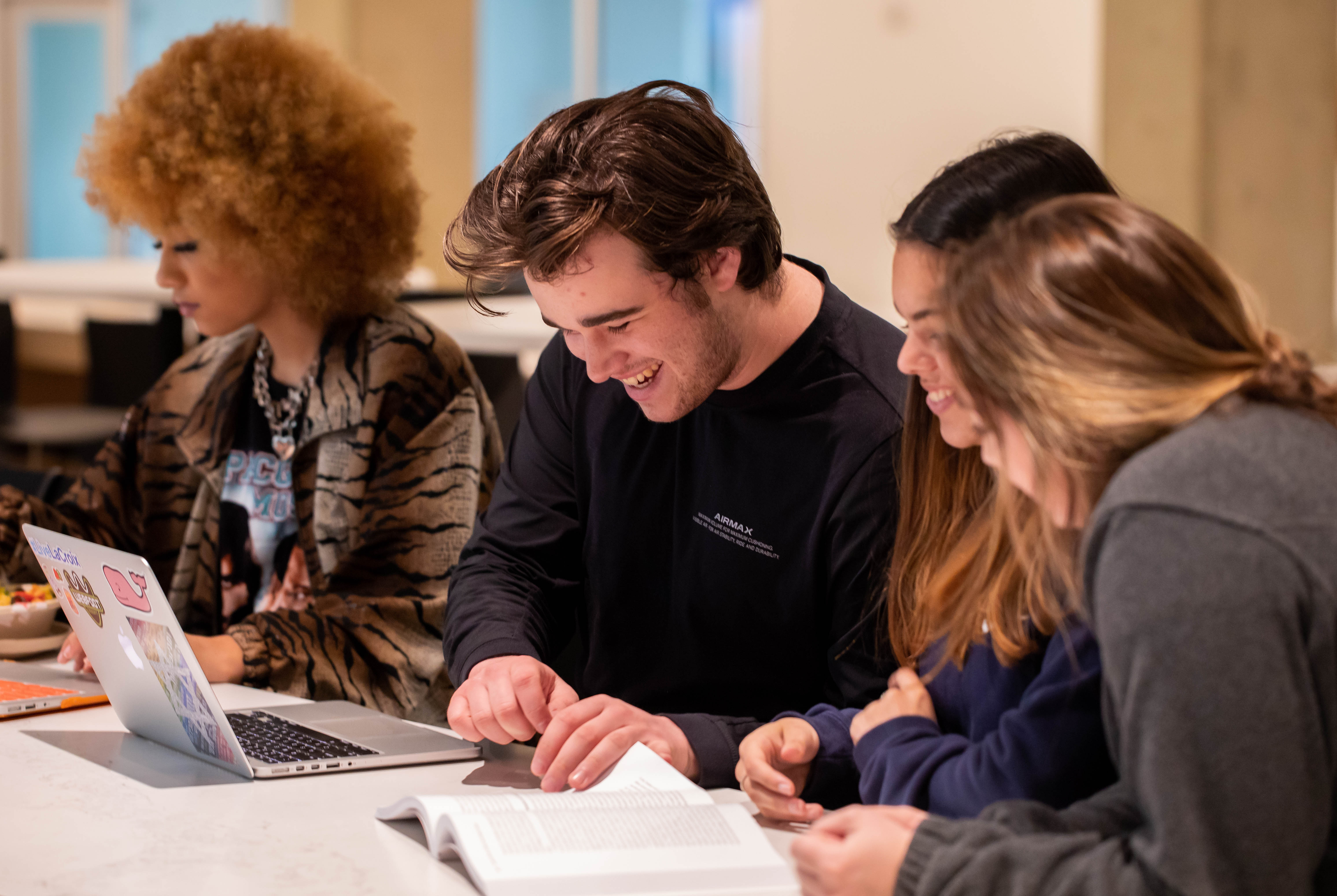 Four students pictured studying.