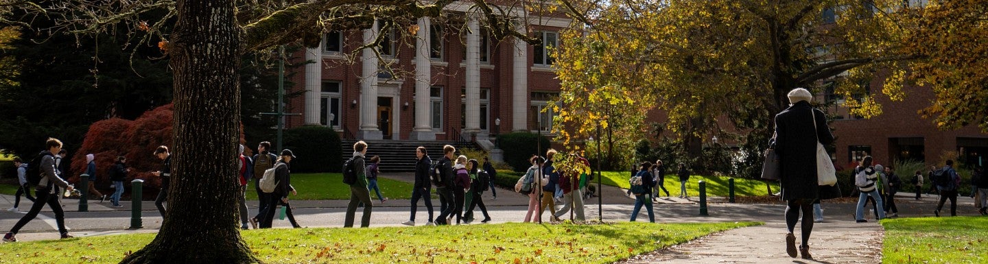 students walk outside Johnson Hall in fall