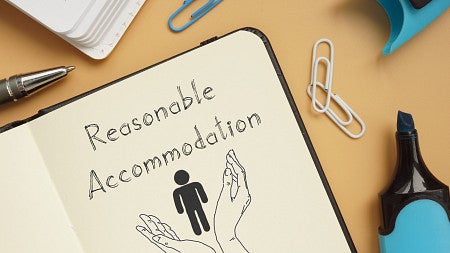 piece of paper in book with "reasonable accommodation" written on it