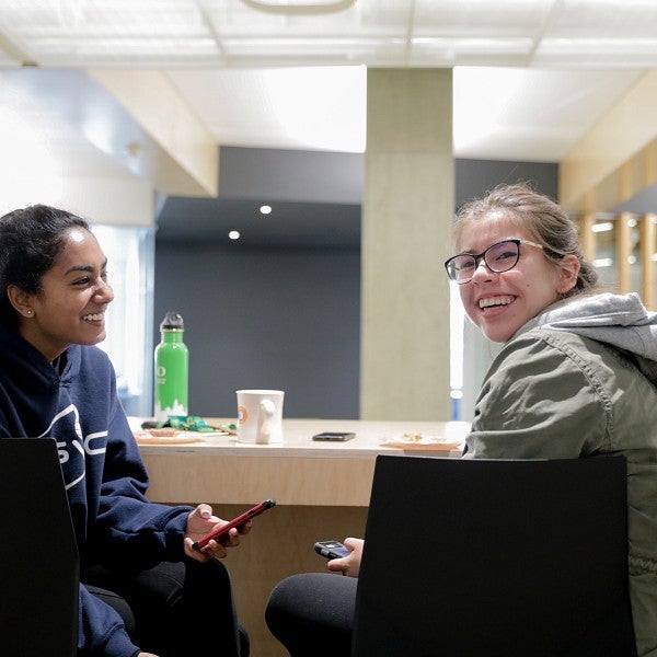 Two students sitting and talking together