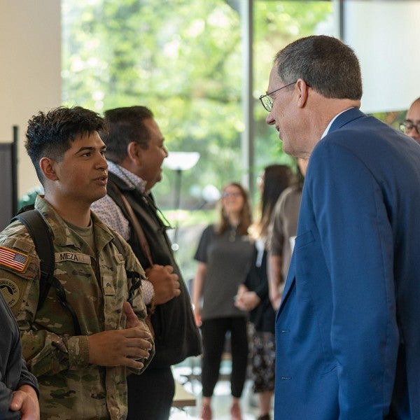 President Karl Scholz speaking with an enlisted student