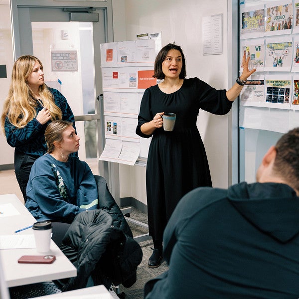 slavka with her students looking at board of graphics