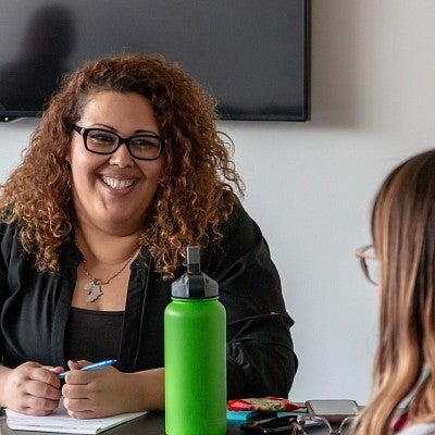 Two people sitting across from each other at a table