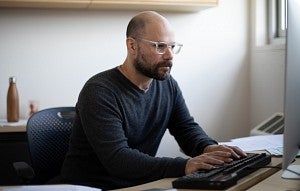 Professor typing at a computer