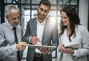 Three colleagues looking at something on a tablet together